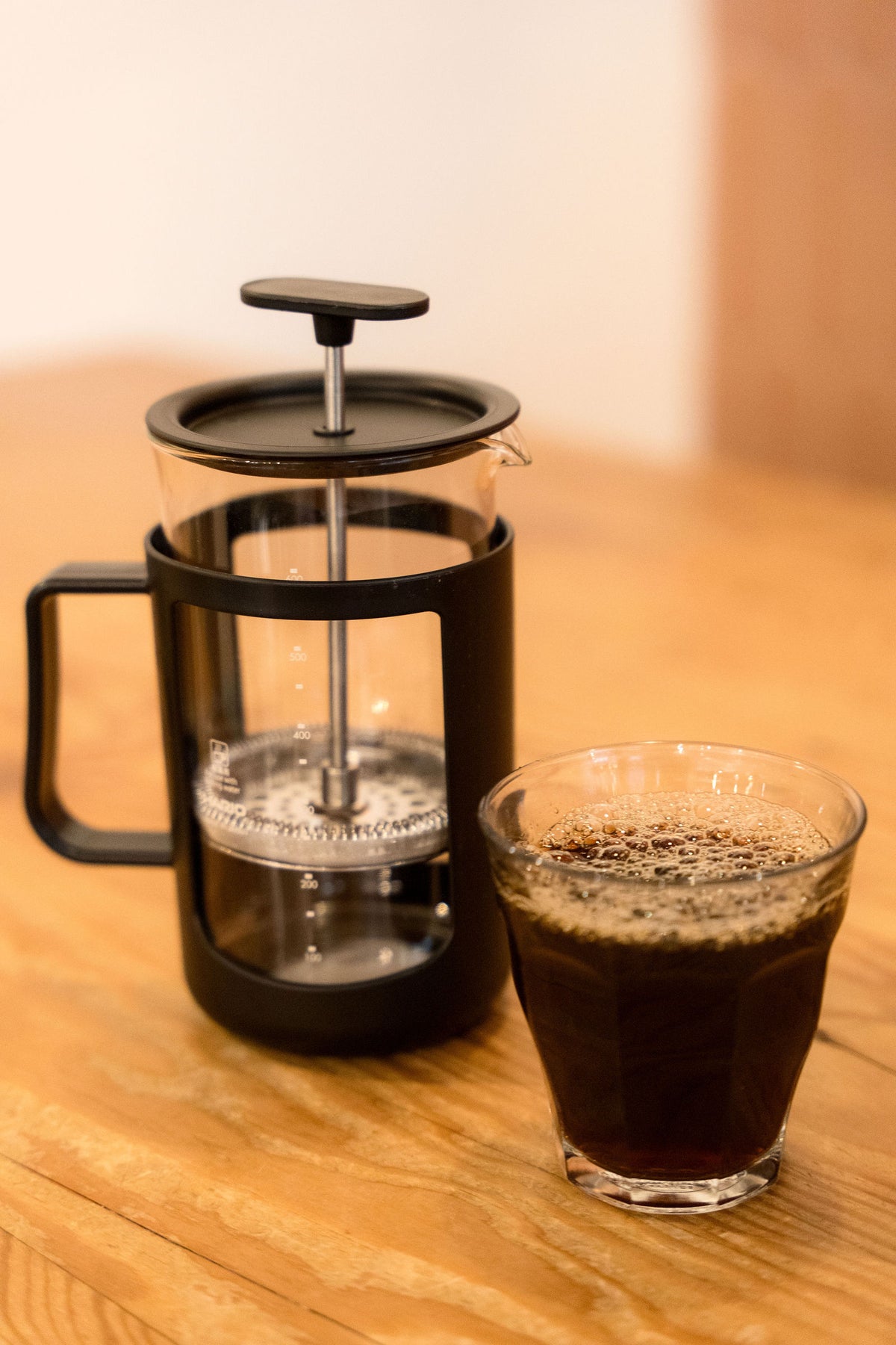 Close-up of a Hario French press and a glass of coffee