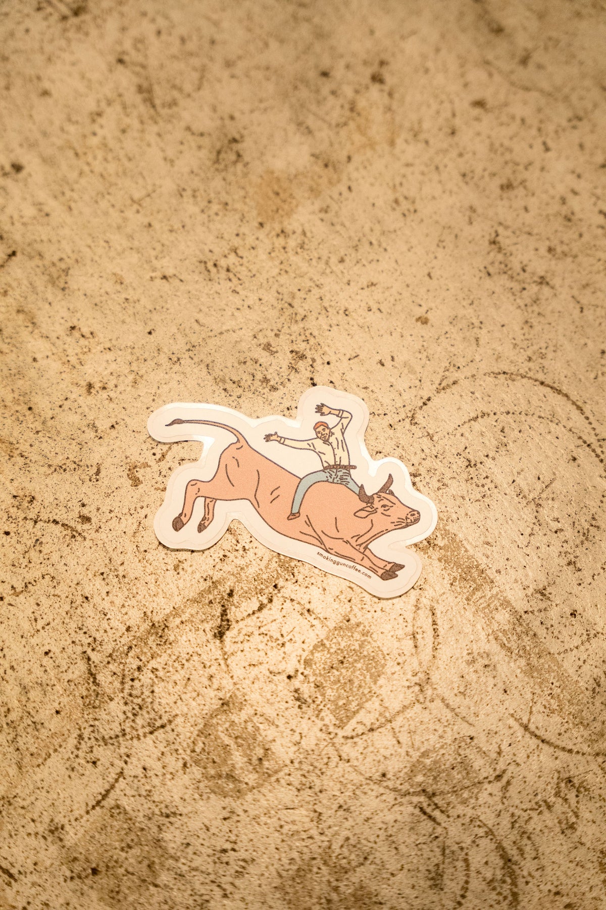 Bull Rider die-cut sticker on a stone counter