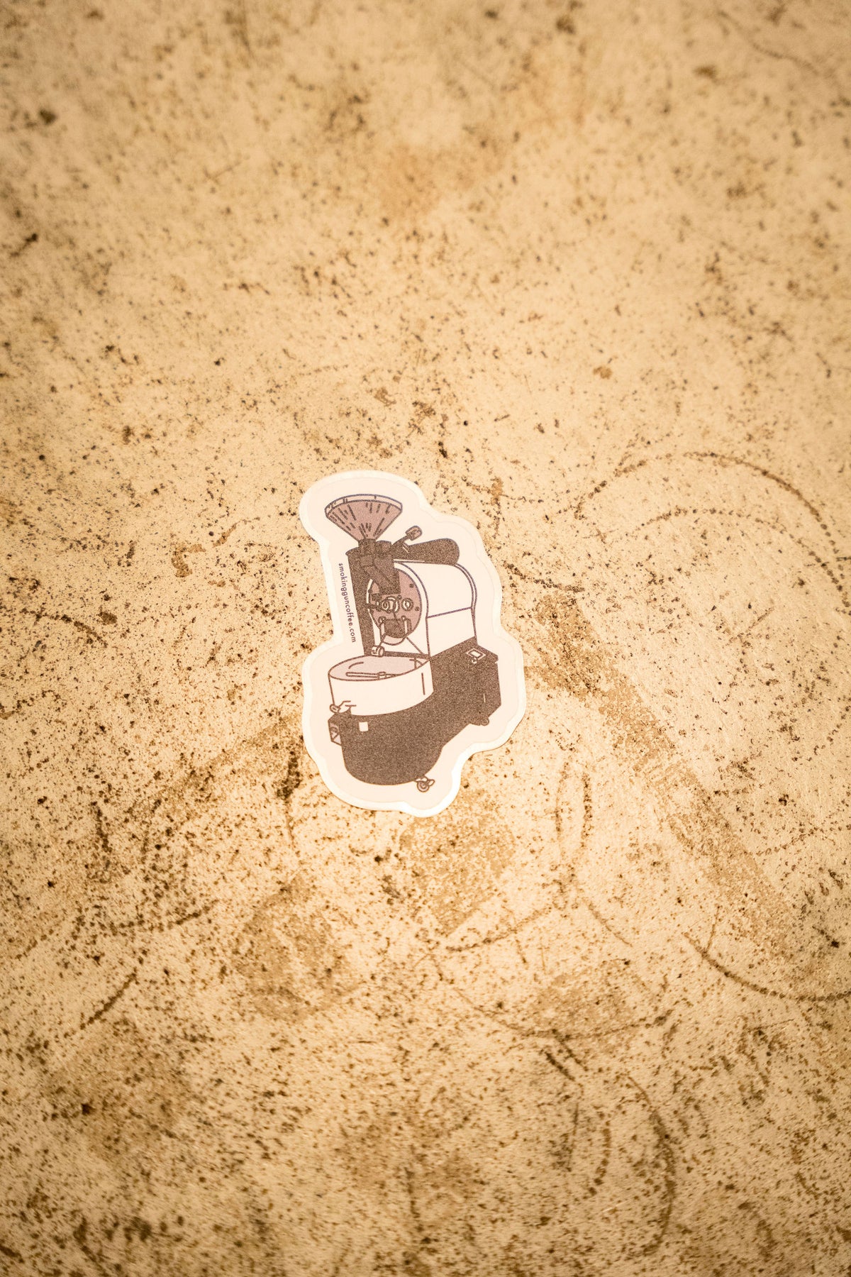 Coffee Roaster die-cut sticker on a stone counter